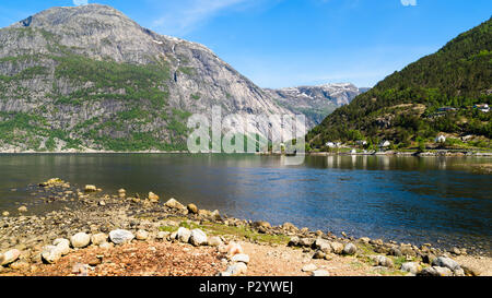 View over the fjord Eidfjorden in Hordaland, Norway, on a sunny and calm day. Stock Photo