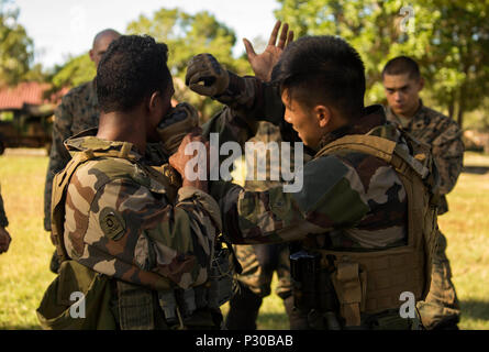 French Armed Forces Sergt. Hlemu Jean and Cpl. Sylvain Nerlet, paratroopers with 3rd Marine Infantry Regiment, demonstrate self-defense techniques during Exercise AmeriCal 16 at Camp Broche, New Caledonia, August 10, 2016. AmeriCal is a bilateral training exercise designed to enhance mutual combat capabilities and improve relations with our partners by exchanging a U.S. Marine Corps and French Armed Forces infantry platoon. While the U.S. Marines are in New Caledonia, the French infantry platoon traveled to Australia to participate in Exercise Koolendong 16 with U.S. and Australian forces. (U. Stock Photo