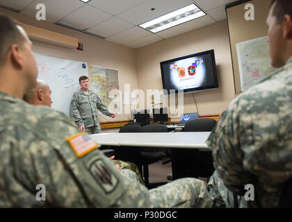 U.S. Air Force Tech. Sgt. William Henry, the 527th Space Aggressor Squadron (SAS) adversary intelligence flight noncommissioned officer in charge, assigned to Schreiver Air Force Base, Colo., briefs U.S. Army Soldiers from Joint Base Elmendorf-Richardson, Alaska, on the capabilities of enemy GPS interference Aug. 8, 2016, during RED FLAG-Alaska 16-3, at Eielson Air Force Base, Alaska. The 527th SAS works with units to teach enemy capabilities and ways to combat the interference of GPS weapon systems during engagements. (U.S. Air Force photo by Staff Sgt. Shawn Nickel) Stock Photo