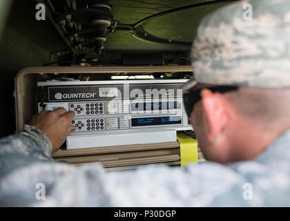 U.S. Air Force Capt. Dustyn Carroll, the 527th Space Aggressor Squadron (SAS) adversary training flight commander assigned to Schreiver Air Force Base, Colo., changes the frequency on two modems to interrupt GPS systems on aircraft Aug. 8, 2016, during RED FLAG-Alaska (RF-A) 16-3, at Eielson Air Force Base, Alaska. The capabilities the space aggressors bring to RF-A 16-3 enables joint and international units to sharpen their combat skills by creating a realistic threat environment. (U.S. Air Force photo by Staff Sgt. Shawn Nickel) Stock Photo