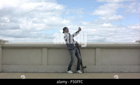 Skateboarder taking olots of selfie. Stock Photo