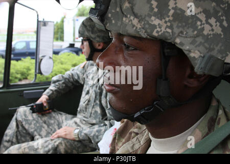 Louisiana National Guard high-water vehicle driver Sgt. Bryant Johnston of the 528th Engineer Company, a native of Bastrop, La., prepares to go on a search and rescue mission with Pvt. Stetson Thompson of Monroe, La., Aug. 16, 2016. The Louisiana National Guard continues to conduct response efforts, recovery missions, and preposition vehicles and assets in potentially affected areas, as directed by Gov. John Bel Edwards, since operations began, Aug. 12. (U.S. Army National Guard photo by Spc. Garrett L. Dipuma) Stock Photo