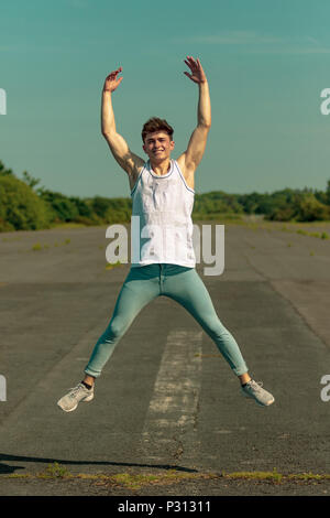 Young teenage boy man jumping with rollerblades inline skates on U ramp ...