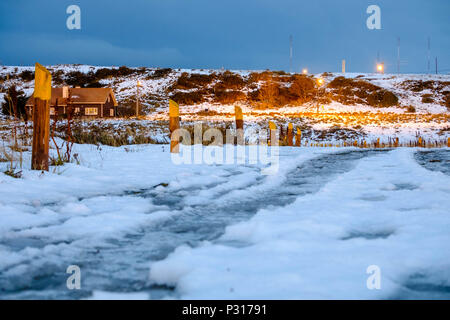 The path next to the 'Bahía Encerrada' in Ushuaia is covered by snow and ice.If it is not too windy, this place is ideal for an evening walk. Stock Photo