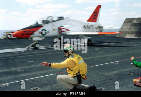 USS THEODORE ROOSEVELT (CVN 71) Apr. 27, 2001 -- A catapult officer 'Shooter' gives the go signal for the T-45 'Goshawk' trainer jet to launch from the flight deck. Stock Photo