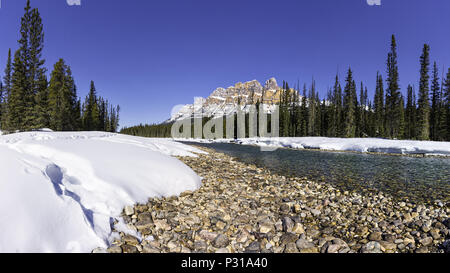 Castle Mountain and Bow River Banff National Park Alberta Canada in the early Spring with melting snow banks on the river bank Stock Photo