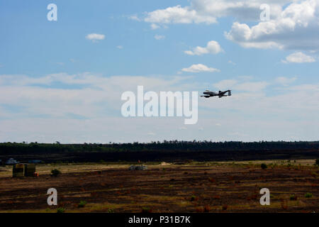 An A-10 Thunderbolt II, a single-seat, twin-engine jet powered by two General Electric TF34-GE-100 turbofan engines, conducted a low-level pass over simulated targets at Camp Grayling Air Gunnery Range during Northern Strike 16. The exercise, involving 5,000 personnel from Army, Air Force, Marine, and Special Forces from 20 states and three coalition countries, focused on close air support, tactical engagement, target identification, precision attack, operational readiness, coordination, joint training, and military skills development. Stock Photo