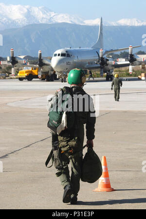 Bay, Crete, Greece (Mar. 14, 2003) -- Patrol Squadron Eight (VP-8) aircrew members walk to their P-3C Orion aircraft to prepare for their next mission.  VP-8, home ported at NAS Brunswick, Maine, is currently deployed to the Mediterranean theater with detachments at Naval Air Station Sigonella, Sicily and Naval Support Activity Souda Bay.  The P-3C is a land-based, long-range, anti-submarine warfare (ASW) patrol aircraft.  It has advanced submarine detection sensors and can carry a mixed payload of weapons internally and on wing pylons. Stock Photo