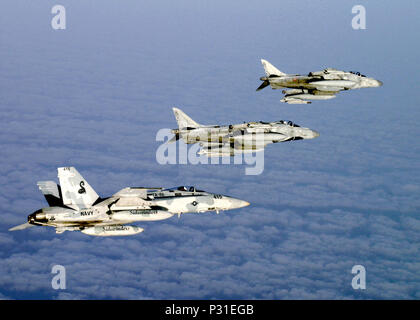 Ocean (July 10, 2004) - Above the clouds over the Atlantic Ocean an F/A-18C Hornet assigned to the 'Sidewinders' of Strike Fighter Squadron Eight Six (VFA-86) flies in formation with two Italian AV-8B Harrier II+ assigned to the Italian Navy aircraft carrier ITS Giuseppi Garabaldi (C 551) after conducting Dissimilar Air Combat Training (DACT). The aircraft are part of Majestic Eagle, a multinational exercise being conducted off the coast of Morocco. The exercise demonstrates the combined force capabilities and quick response times of the participating naval, air, undersea and surface warfare g Stock Photo