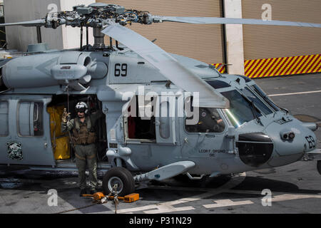 US Navy An air crewman checks a JP-5 aviation fuel sample for an HH-60H ...