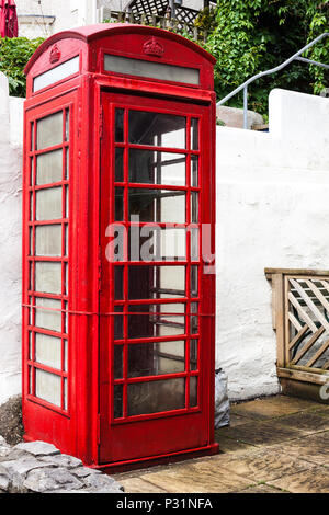 Paleokastritsa, Cofru, Greece- MAY 10, 2018 Red phone boot on the street. Traditional London red phone boot. Red object on the street. Functional phon Stock Photo