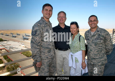 The President of the 2017 Tournament of Roses Parade, Mr. Brad Ratliff, with his wife Susan (center) pause for a photo on the catwalk of the air traffic control tower with Technical Sgt. Timothy Shaw, (left) percussionist, and Captain Raphael Toro-Quinones, (right) commander,  both with the U.S. Air Force Band of the Golden West,  during a recent visit, Aug 19, 2016, Travis AFB, Calif. Mr. Ratliff was visiting Travis to present the Tournament of Roses flag to the U. S. Air Force Band of the Golden West and to receive a brief orientation on the Air Force mission to improve relations between the Stock Photo