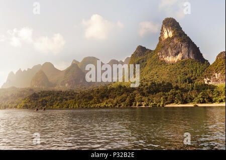 Boats on Li river near Yangshuo, Guangxi province, China. Picturesque Karst mountains along the river. Stock Photo