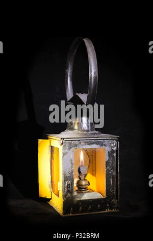 Old railroad petrol lantern with fire inside Stock Photo