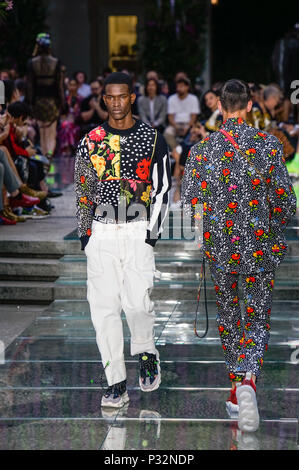 MILAN, ITALY - JUNE 16, 2019: Man with green metallic trousers and Moschino  sneakers before Palm Angels fashion show, Milan Fashion Week street style  Stock Photo - Alamy