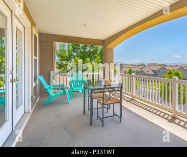 Patio area off of master bedroom with table and chairs Stock Photo