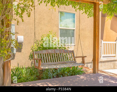 Swing on deck with Gazebo in Utah Valley. Green vines growing up the gazebo for shade. Stock Photo