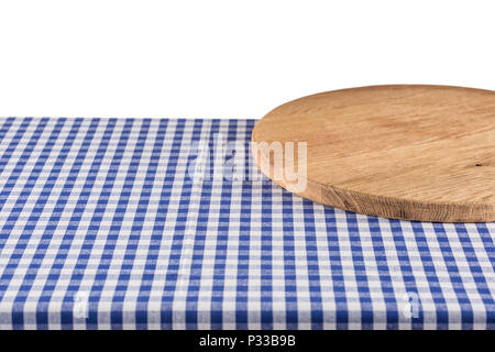 Empty wooden pizza board on blue checkered tablecloth isolated on white. Stock Photo