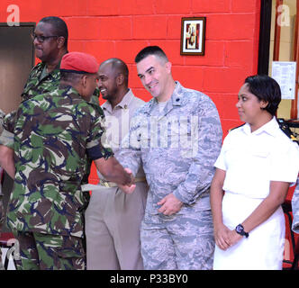 CHAGUARAMAS, Trinidad- Lt. Col. Jason Brugman, state partnership program coordinator, Joint Force Headquarters, congratulates a member of the Trinidad and Tobago Defence Force Reserves during an award ceremony held on Aug. 11, 2016. (U.S. Air National Guad photo by Tech. Sgt. Gwendolyn Blakley). Stock Photo