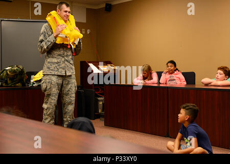 Airmen 1st Class Alan Kordzikowski inflates an emergency life preserver during an aircrew flight equipment demonstration at Stewart Air National Guard Base August 23. The demonstration was part of  Moose Camp, an annual day camp for children of the 105th Airlift Wing's Airmen. The kids take part in a variety of events to build teamwork and get a better understanding of the diverse missions their parents are responsible for. (U.S. Air Force photo by Staff Sgt. Julio A. Olivencia Jr.) Stock Photo