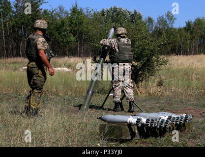 YAVORIV, Ukraine - A Ukrainian mortarman loads a round on the mortar weapon system during mortar live-fire training August 29, 2016. Soldier of 6th Squadron, 8th Cavalry Regiment, 2nd Infantry Brigade Combat Team, 3rd Infantry Division   are here in support of the Joint Multinational Training Group-Ukraine. JMTG-U focuses on building a sustainable and enduring training capacity and capability within the Ukrainian land forces. (U.S.Army photo by Spc. John Onuoha / Released) Stock Photo