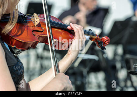 musician playing violin instrument on street concert. closeup view Stock Photo