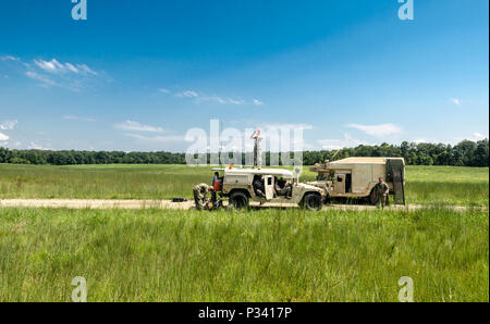 FORT CAMPBELL, KY. - Members of the 861st Quartermaster Company on the ground monitor the environmental factors and communicate any changes that may be unsafe to those that will be deploying from the aircraft. Stock Photo