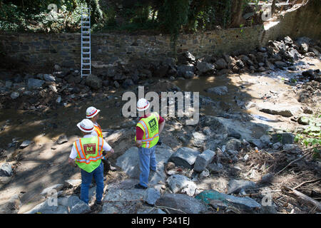 Crew members of the U.S. Army Corps of Engineers, Baltimore District and contractors clear large debris restricting drainage from the Hudson River in the Historic District of Ellicott City, Md., Aug. 20, 2016. The Corps is providing assistance through a cooperative agreement with Maryland Emergency Management Agency to help local and state recovery efforts after a deadly flash flood hit the city. (U.S. Army photo by Alfredo Barraza) Stock Photo