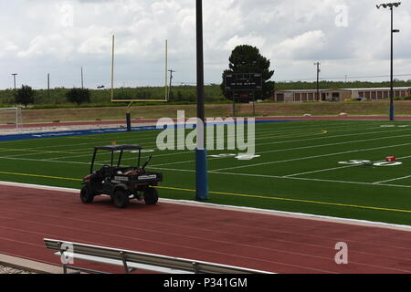 The football field at Goodfellow Air Force Base, Texas, underwent turf replacement from August 12 to August 31, 2016. The Air Force logo is displayed at midfield. The project involved planning, installation, and quality assurance to provide a safe and durable field for physical training, athletic programs, and recreational activities for base personnel and cadets. Stock Photo