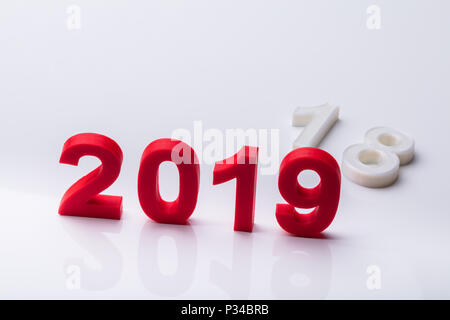 Year 2019 Replaced With Old Year 2018 Over Reflective Background Stock Photo