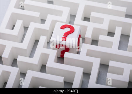 High Angle View Of White Cube With Question Mark Sign In The Centre Of Maze Stock Photo