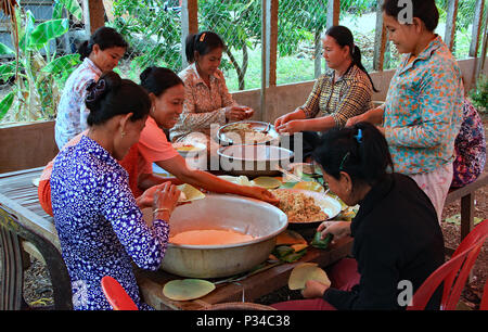 The day before the wedding the family prepares the wedding feast, filling banana leaf packages with sweetmeats. Stock Photo