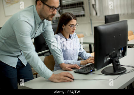 Young students presenting e-learning service in classroom Stock Photo