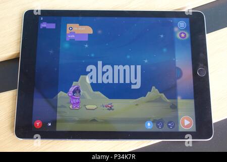 Tynker: Coding for Kids app on an Ipad Air, displaying the drag and drop visual programming for children Stock Photo