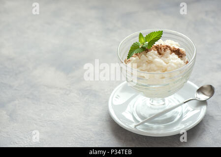 Rice Pudding with Cinnamon. Healthy traditional homemade dessert or breakfast - Rice Pudding, copy space. Stock Photo