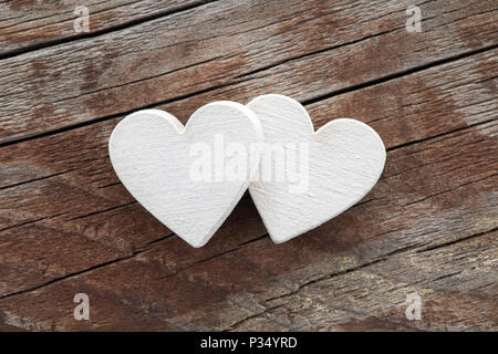 Two hearts on old wooden background Stock Photo