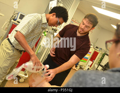 Science Service Medicine and Mentoring program is an internship initiative at Naval Hospital Jacksonville focused on healthcare education and training. The archival image documents cardiopulmonary resuscitation airway ventilation instruction during a June 14, 2018 simulation session for participating high school students. Stock Photo