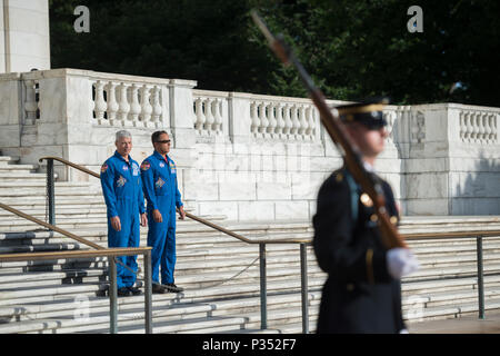 NASA astronauts Mark Vande Hei (left) and Joe Acaba (right) watch the Changing of the Guard Ceremony at the Tomb of the Unknown Soldier at Arlington National Cemetery, Arlington, Virginia, June 15, 2018. While at ANC, Vande Hei and Acaba presented to Col. Jerry Farnsworth, chief of staff, Arlington National Cemetery and Army National Military Cemeteries, an ANC Employee Patch that was flown aboard the International Space Station (ISS) during Expeditions 53/54. They also presented Col. Jason Garkey, regimental commander, 3d U.S. Infantry Regiment (The Old Guard), with a Tomb Guard Identificatio Stock Photo