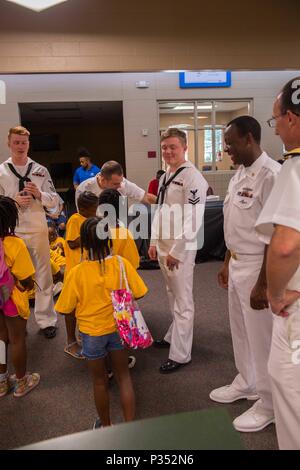 180615-N-SH284-1086 CHATTANOOGA, Tenn. (June 15, 2018) Members of the Ohio-class ballistic-missile submarine USS Tennessee (SSBN 734), interact with children at the Highland Park Boys and Girls Club during Chattanooga Navy Week. Navy Weeks are designed to connect the public with Navy Sailors, programs and equipment throughout the country. Every year, America's Navy comes home to approximately 15 cities across the country to show Americans why having a strong Navy is critical to the American way of life. (U.S. Navy photo by Mass Communication Specialist 2nd Class Vaughan Dill/Released) Stock Photo