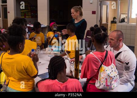 180615-N-SH284-1099 CHATTANOOGA, Tenn. (June 15, 2018) Lauren Boring, Naval Oceanographic Office civilian scientist and Aerographer's Mate 1st Class Class Christopher Thompson, assigned to the Naval Oceanographic Office, Sea Survey Component demonstrate buoyancy to children at the Highland Park Boys and Girls Club during Chattanooga Navy Week. Navy Weeks are designed to connect the public with Navy Sailors, programs and equipment throughout the country. Every year, America's Navy comes home to approximately 15 cities across the country to show Americans why having a strong Navy is critical to  Stock Photo