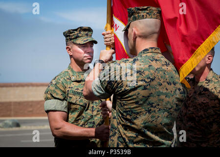 Lt. Col. Bradley Ledbetter, commanding officer, 1st Marine Support Raider Battalion, U.S. Marine Corps Forces, Special Operations Command, left, receives the guidon from Lt. Col. Richard Martin, previous commanding officer, 1st MRSB, MARSOC, during a change of command ceremony at Marine Corps Base Camp Pendleton, California, June 15, 2018. The passing of the unit guidon symbolized the transfer of responsibility, authority and accountability of the command and it’s Marines. (U.S. Marine Corps photo by Lance Cpl. Betzabeth Y. Galvan) Stock Photo