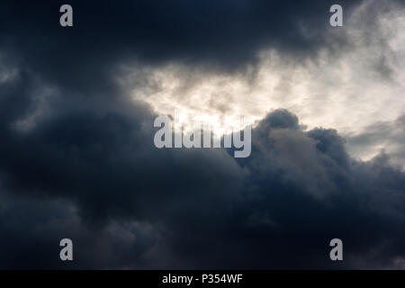 dark dense gloomy dramatic thundercloud on summer day Stock Photo