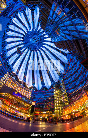 Berlin, Germany, May 13th 2016: People having a walk under the changing colours of the Sony Center building complex at the Potsdamer Platz Stock Photo