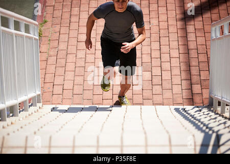young asian adult male athlete using steps to train speed and strength. Stock Photo