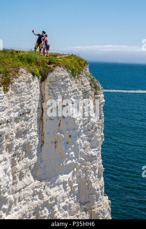 Taking a family selfie on the cliff edge, Jurassic Coast World Heritage Site, Dorset, England, UK Stock Photo