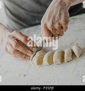 Process of cutting dough making dish cooking homemade dough. Chef makes fresh dough Stock Photo