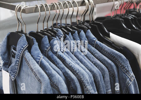 fashion jeans jacket on hangers. Stock Photo
