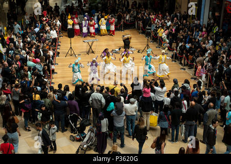 The Cubs of Punjab, a young Bhangra dancing troupe, perform an energetic routine to an appreciative audience in Birmingham's Bullring Shopping Centre. Stock Photo