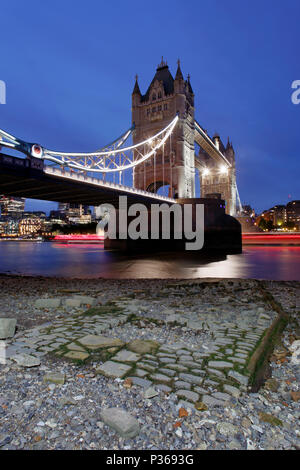 Tower Bridge, The Victorian cobbled jetty and light trails. from a low POV at low tide on the Thames foreshore Stock Photo