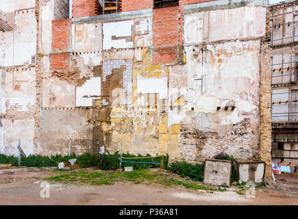 Demolished building in Malaga, old wall with apartment blocks.Malaga, Spain. Stock Photo